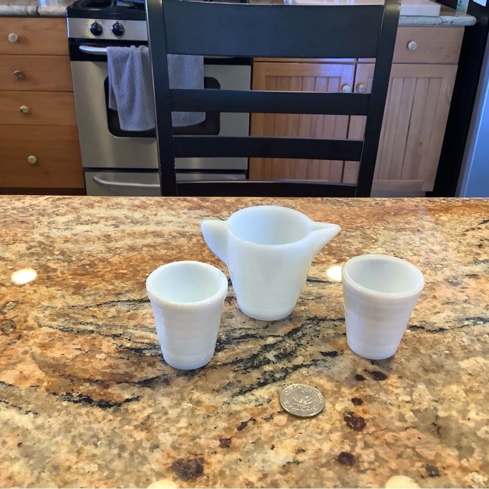 Small white glass pitcher with 2 cups
